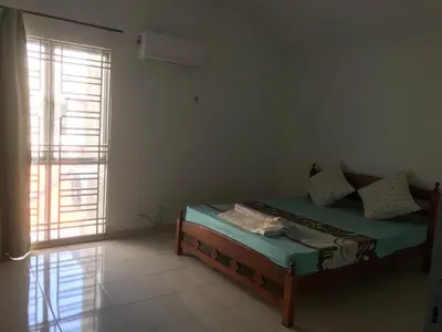 a bedroom with a bed in a room with a window at Batu Kawan Home in Simpang Ampat