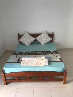 a bed with two pillows on top of it at Batu Kawan Home in Simpang Ampat