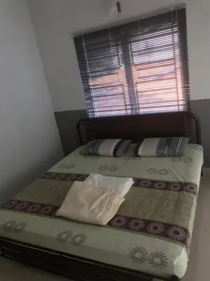 a bed in a room with a window at Batu Kawan Home in Simpang Ampat