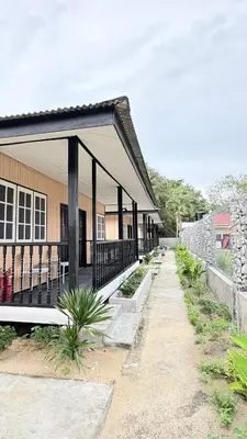 a building with a porch with chairs on it at Alva Boutique Chalet Pangkor in Pangkor