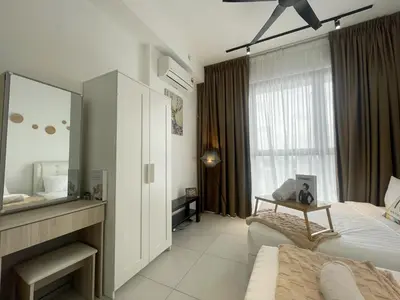 a bedroom with a bed and a mirror and a tv at Le Petit Suite - 8 Pax Sea View Infinity Pool in George Town
