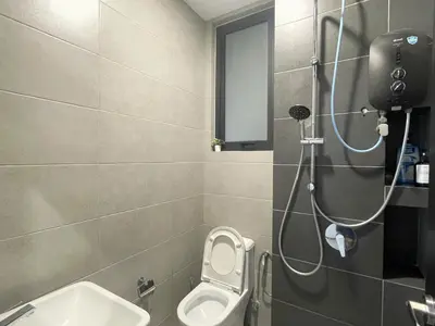 a bathroom with a shower with a toilet and a sink at Le Petit Suite - 8 Pax Sea View Infinity Pool in George Town
