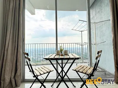 a table and chairs on a balcony with a view at Taiping Crystal Creek Condo Pool Gym Netflix in Taiping