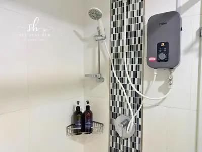 a shower in a bathroom with a phone on the wall at Seaview Maritime Suites, Penang George Town, Karpal Singh Drive-Free Parking by The Stay Hub in George Town
