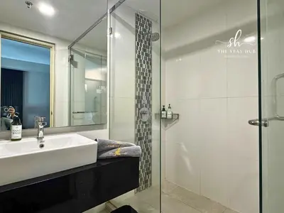 a bathroom with a sink and a glass shower at Seaview Maritime Suites, Penang George Town, Karpal Singh Drive-Free Parking by The Stay Hub in George Town