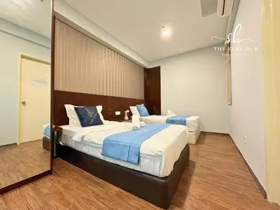 a bedroom with two beds and a large mirror at Seaview Maritime Suites, Penang George Town, Karpal Singh Drive-Free Parking by The Stay Hub in George Town