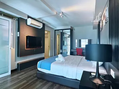 a hotel room with a bed and a tv at Seaview Maritime Suites, Penang George Town, Karpal Singh Drive-Free Parking by The Stay Hub in George Town