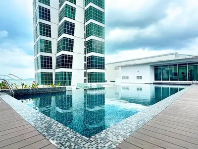 a building with a swimming pool in front of a building at Seaview Maritime Suites, Penang George Town, Karpal Singh Drive-Free Parking by The Stay Hub in George Town