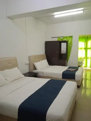 a hotel room with two beds and a tv at Cool view budget hotel in Cameron Highlands