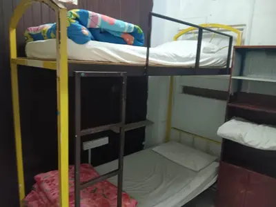 two bunk beds in a small room with another bed at Cool view budget hotel in Cameron Highlands