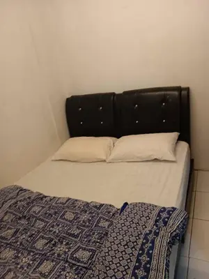a bed with a black head board and two pillows at Cool view budget hotel in Cameron Highlands