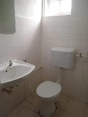 a bathroom with a white toilet and a sink at Cool view budget hotel in Cameron Highlands