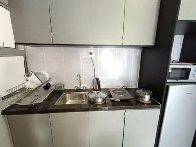 a kitchen with a sink and a counter top at Family Suite at Cameron Golden Hills in Brinchang