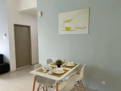 a white dining room with a table and chairs at Family Suite at Cameron Golden Hills in Brinchang