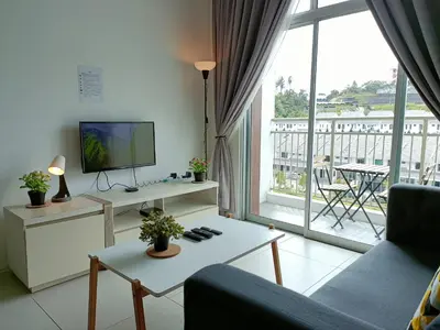 a living room with a tv and a large window at Family Suite at Cameron Golden Hills in Brinchang