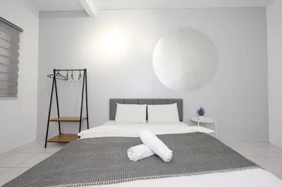 a white bedroom with a large bed with white pillows at Family Getaway with Home Comforts Brinchang Cameron Highland Clover Home 2-23A in Brinchang