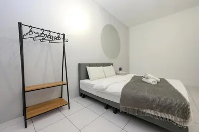 a bed in a white room with a white floor at Family Getaway with Home Comforts Brinchang Cameron Highland Clover Home 2-23A in Brinchang