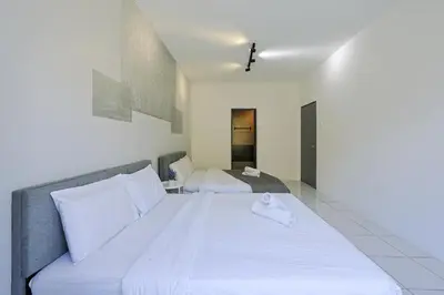 a bedroom with a large bed with white sheets at Family Getaway with Home Comforts Brinchang Cameron Highland Clover Home 2-23A in Brinchang