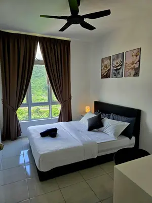 a bedroom with a bed with a ceiling fan at b08 The Anderson Ipoh Family Stay 2BR in Ipoh