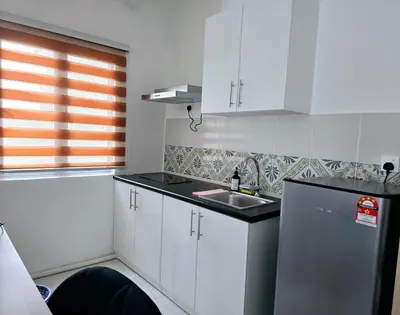 a small kitchen with white cabinets and a sink at b08 The Anderson Ipoh Family Stay 2BR in Ipoh
