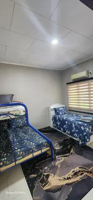 a room with two bunk beds in a room at TunTeja Homestay in Sungai Petani