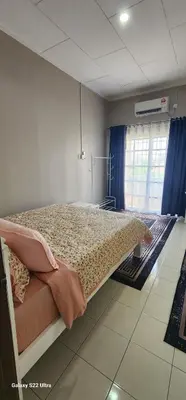 a bedroom with a bed in a room at TunTeja Homestay in Sungai Petani