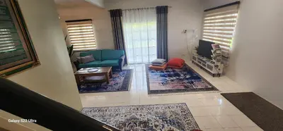 a living room with a couch and a chair at TunTeja Homestay in Sungai Petani
