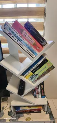 a stack of books sitting on top of a shelf at TunTeja Homestay in Sungai Petani