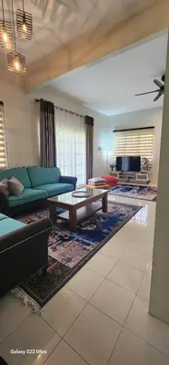 a living room with a couch and a coffee table at TunTeja Homestay in Sungai Petani