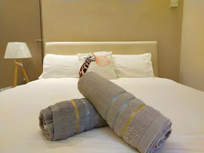 a blanket on a bed with a stuffed animal on it at 193 Breeze Single Terrace 3BR2B 10pax in Ipoh