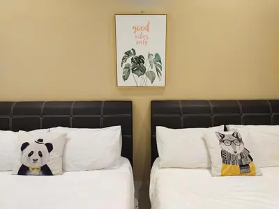 two beds with white sheets and a panda bear on them at 193 Breeze Single Terrace 3BR2B 10pax in Ipoh