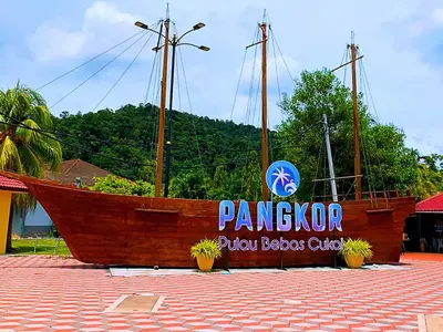 a large wooden boat with a sign on it at Pangkor Island Pool View Studio 2 Queen Beds 2 Min Walk to the Beach Free WiFi & Parking in Pangkor