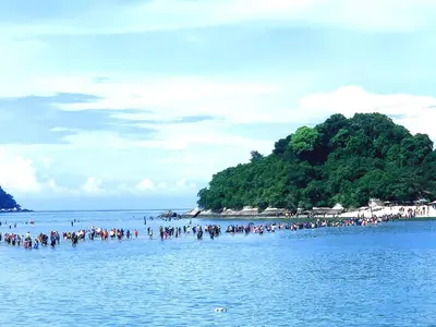 a group of people on a beach in the water at Pangkor Island Pool View Studio 2 Queen Beds 2 Min Walk to the Beach Free WiFi & Parking in Pangkor