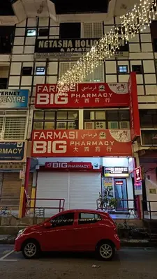 a red car parked in front of a building at Cool view hostel in Tanah Rata