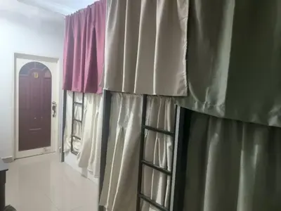 a room with some curtains and a door and a hallway at Cool view hostel in Tanah Rata