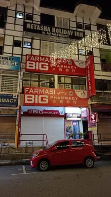 a red car parked in front of a building at Cool view hostel in Tanah Rata