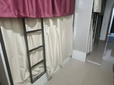 a ladder next to a window in a room at Cool view hostel in Tanah Rata