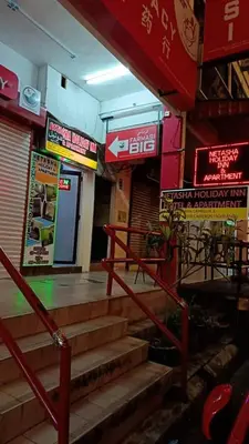 a set of stairs in a building with signs at Cool view hostel in Tanah Rata