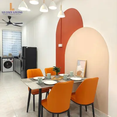 a dining room with a table and orange chairs at The Cozy Retreat House at Bukit Mertajam in Bukit Mertajam