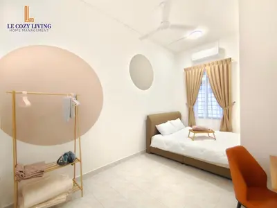 a bedroom with a bed and a mirror at The Cozy Retreat House at Bukit Mertajam in Bukit Mertajam