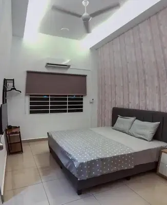 a bedroom with a large bed in a room with a window at TK Homie in Tanjung Karang