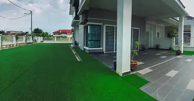 an image of a yard with green grass at TK Homie in Tanjung Karang