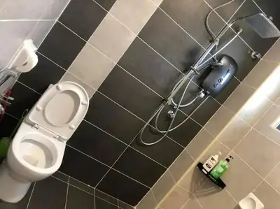 a bathroom with a toilet and a hair dryer at TK Homie in Tanjung Karang