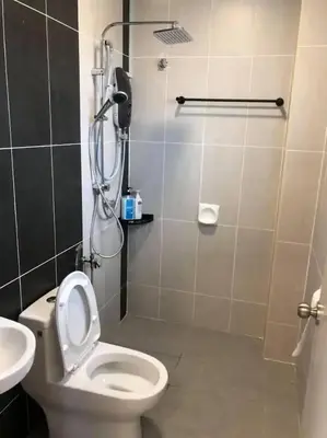 a bathroom with a shower with a toilet and a sink at TK Homie in Tanjung Karang