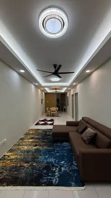 a living room with a couch and a ceiling fan at Homestay Tapah by homestay uitm tapah in Tapah Road