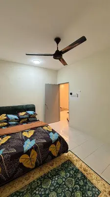 a bedroom with a bed and a ceiling fan at Homestay Tapah by homestay uitm tapah in Tapah Road