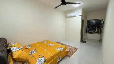 a living room with a bed and a ceiling fan at Homestay Tapah by homestay uitm tapah in Tapah Road