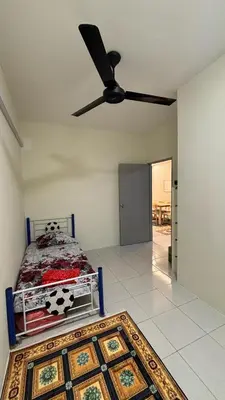 a bedroom with a bed and a ceiling fan at Homestay Tapah by homestay uitm tapah in Tapah Road