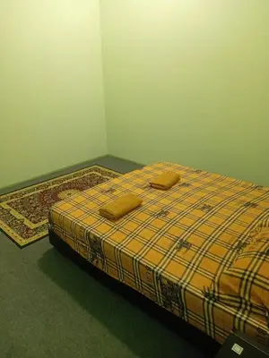 a bed in a room with two pillows on it at Tambun Lastworld Sapari Homestay in Tambun
