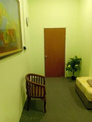 a room with a bed and a chair and a door at Tambun Lastworld Sapari Homestay in Tambun